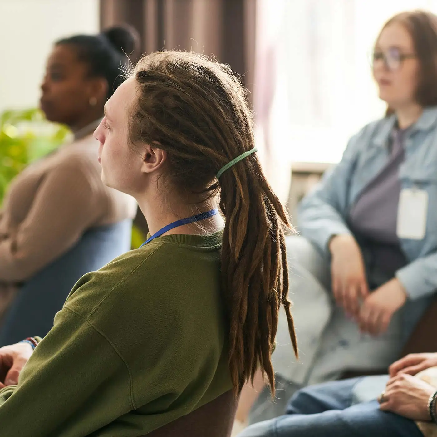 group-of-adults-sitting-in-a-meeting